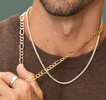 Closeup image of a man wearing a cross pendant necklace.